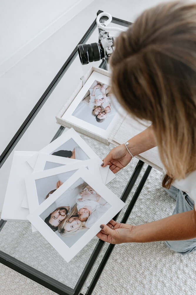 Natasha sorting mounted photographs